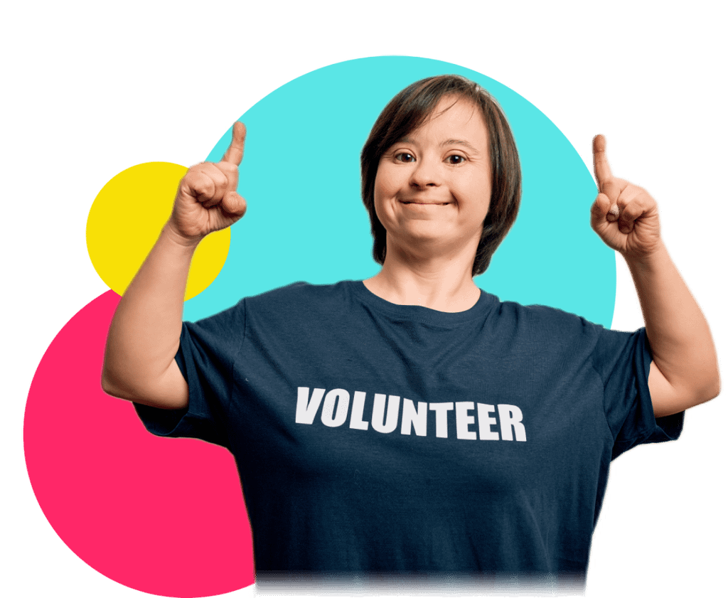 A young woman pointing up, wearing a t-shirt that says 'Volunteer', against a colourful abstract background